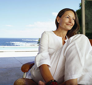 Woman thinking about retirement planning with an ocean view