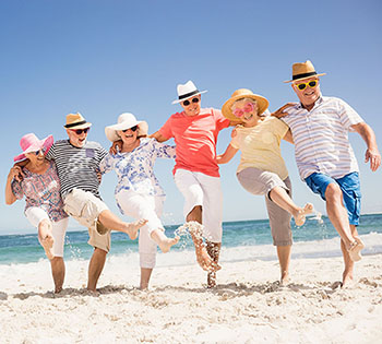 A Group of friends on Palm Beach County beach enjoying retirement thanks to Velocity Community Investment Services